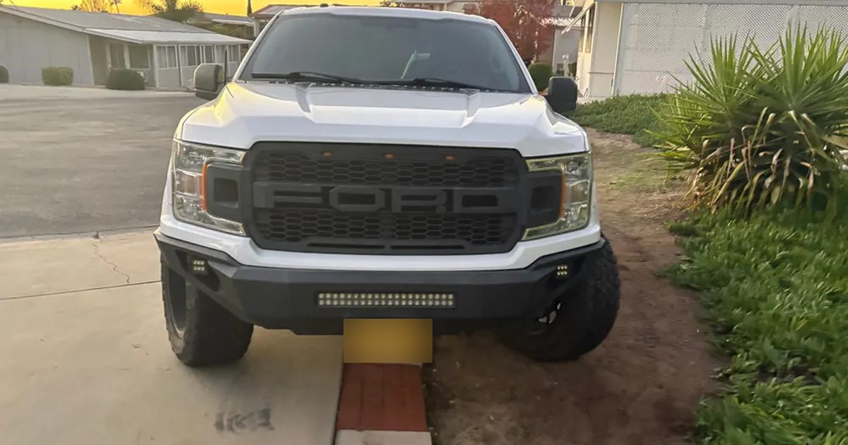 A white Ford F-150 parked in a Hemet driveway at sunrise for a mobile diagnosis