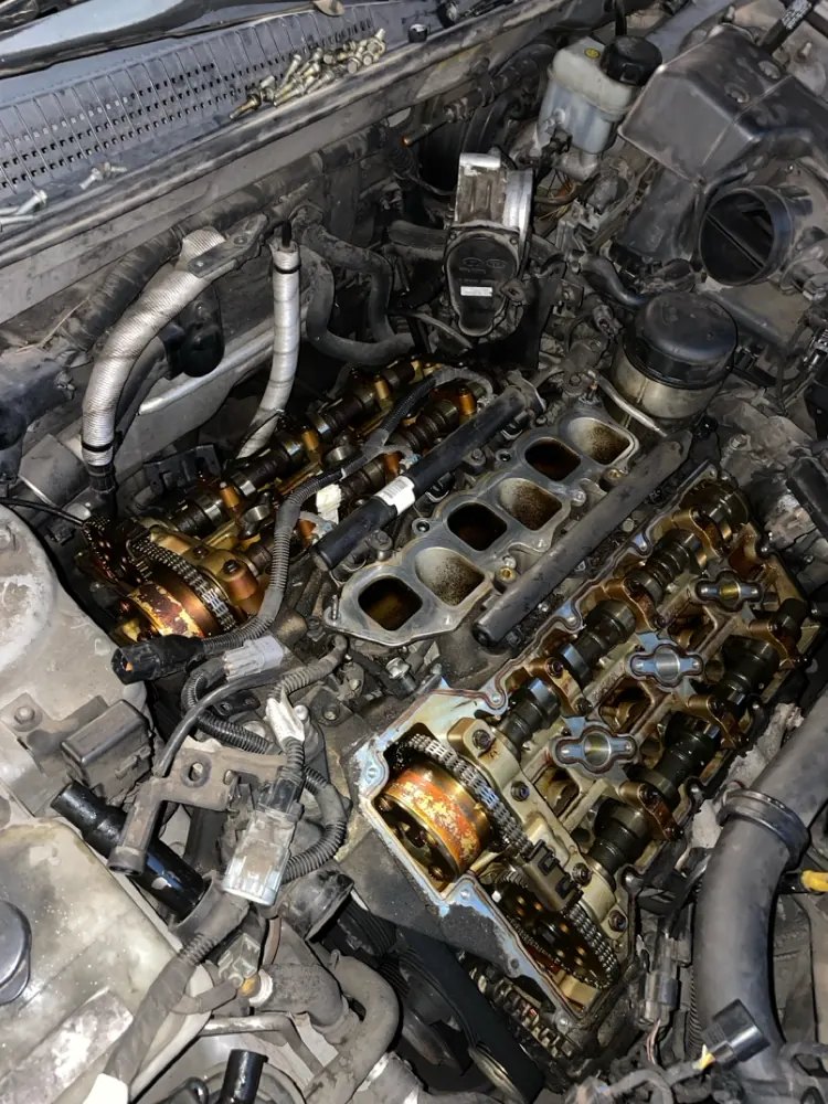 An engine with the valve covers off showing both timing chains and the cam gears