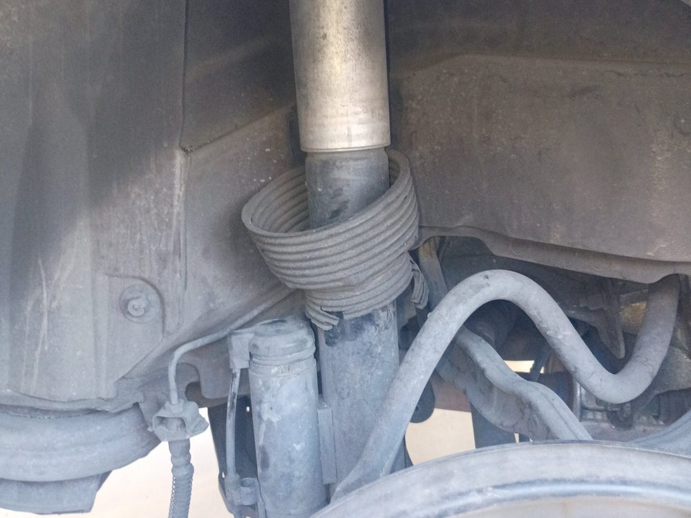 A front strut and coil spring inside the wheel well