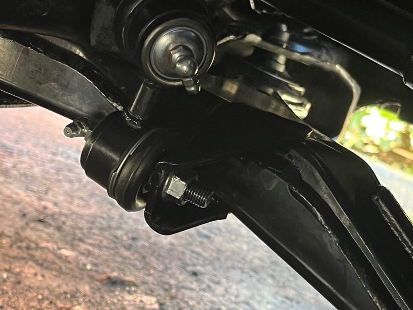 A new lower ball joint bolted to a control arm