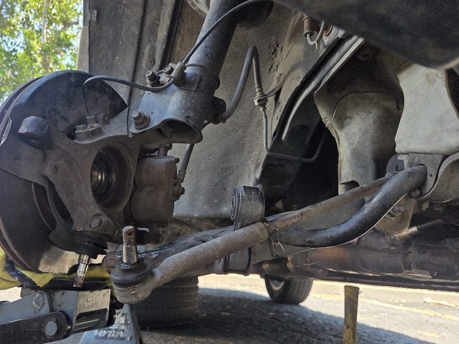 A front wheel hub and steering knuckle with the tie rod end unhooked